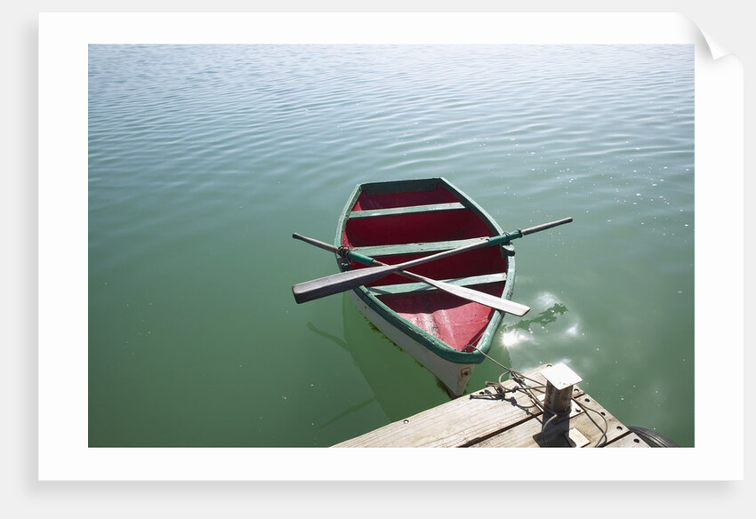 Rowing boat moored at the end of a jetty by Anonymous