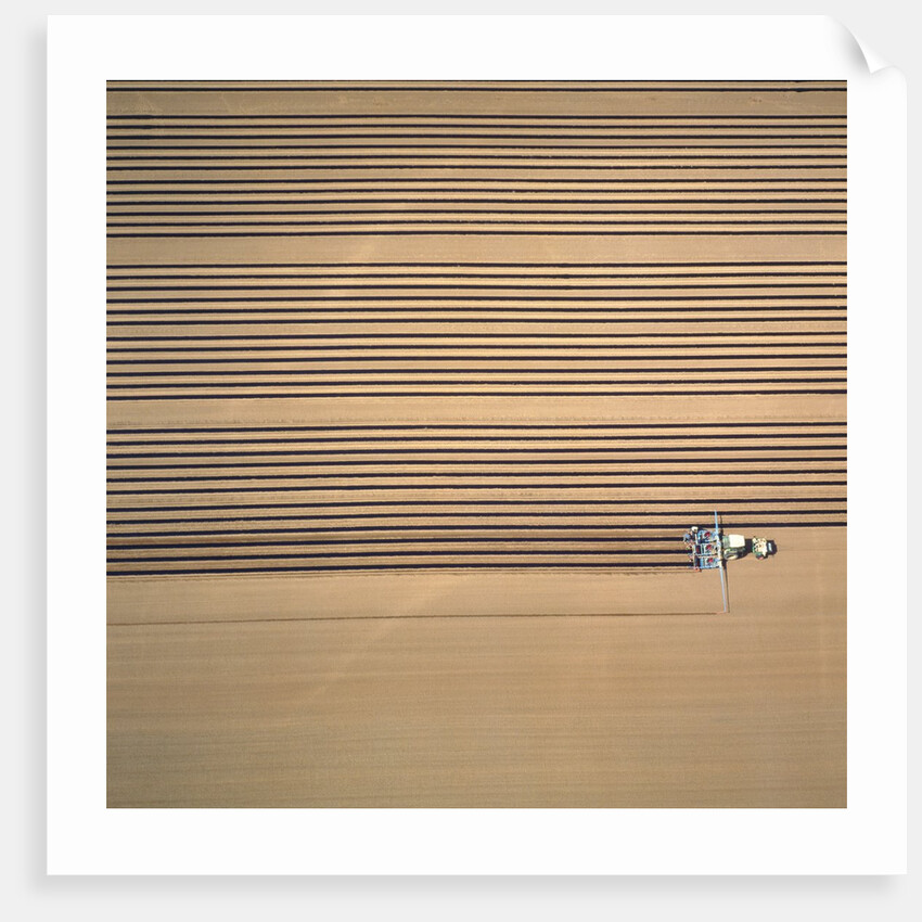 Aerial shot of a tractor cultivating by Anonymous