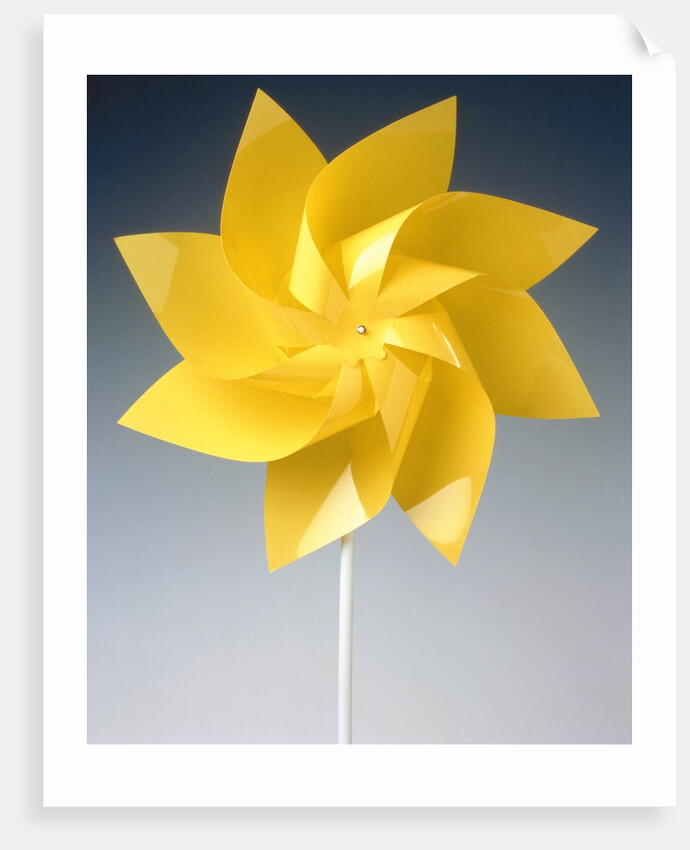 Toy wind wheel in front of a gray background by Anonymous