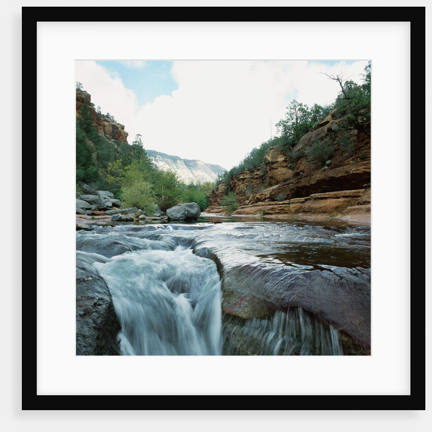Low angle view of stream running through rural setting by Anonymous