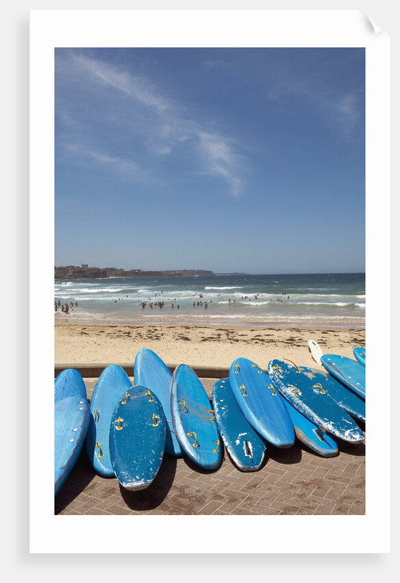View of stacked up surfboards at the beach by Anonymous