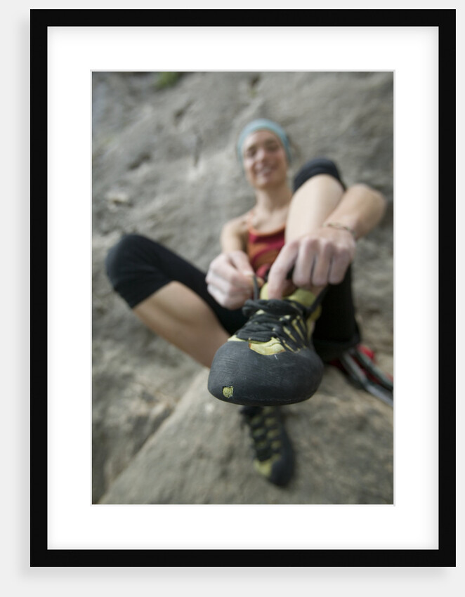 Woman Putting on Rock Climbing Shoes by Anonymous