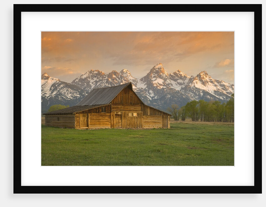 Log Barn in Meadow near Mountain Range by Anonymous