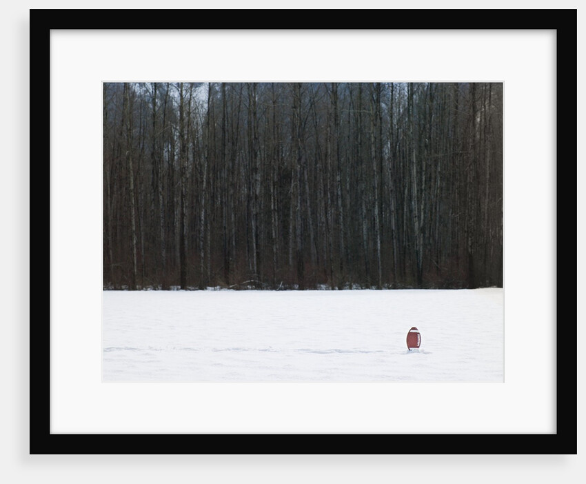 Football in Snow Covered Field by Anonymous