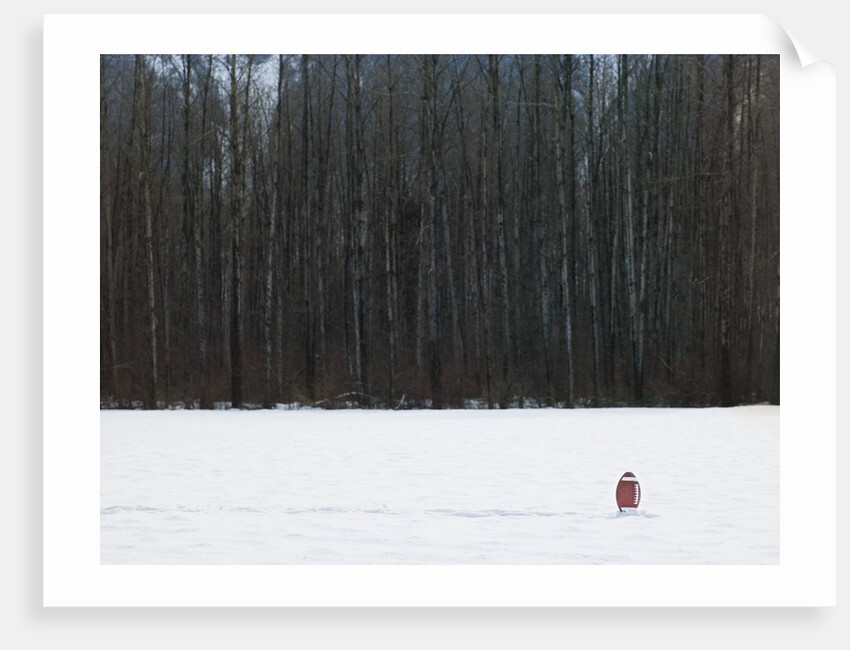 Football in Snow Covered Field by Anonymous