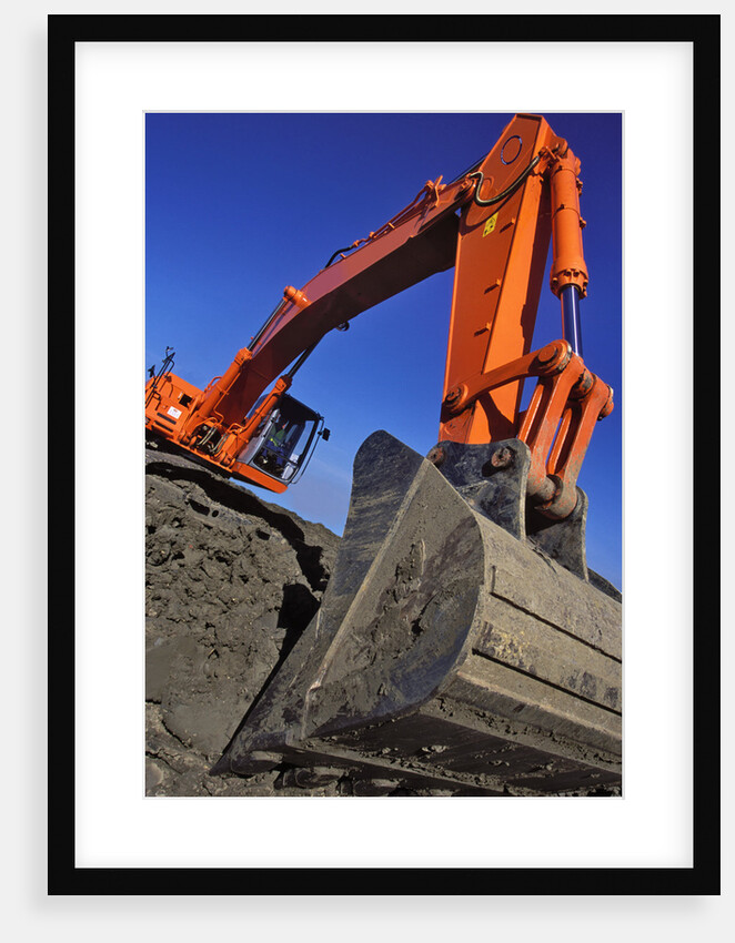 Backhoe Working on Muddy Construction Site by Anonymous