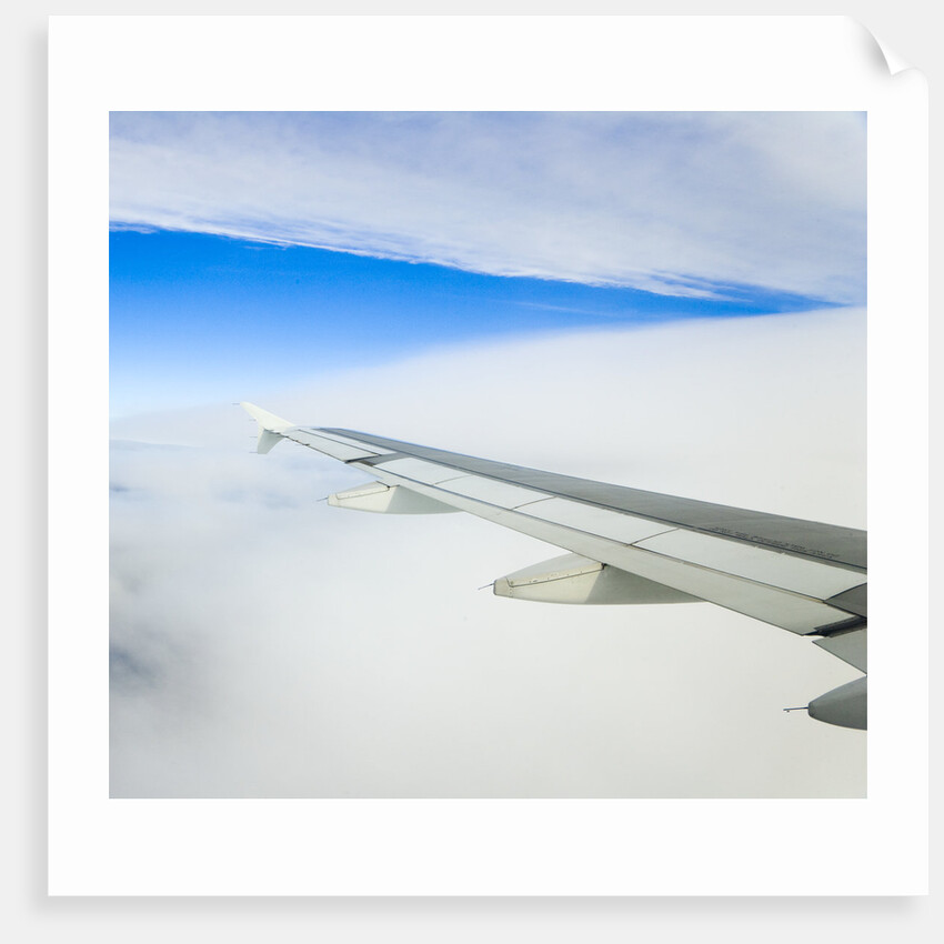 Airplane Wing Above Clouds by Anonymous
