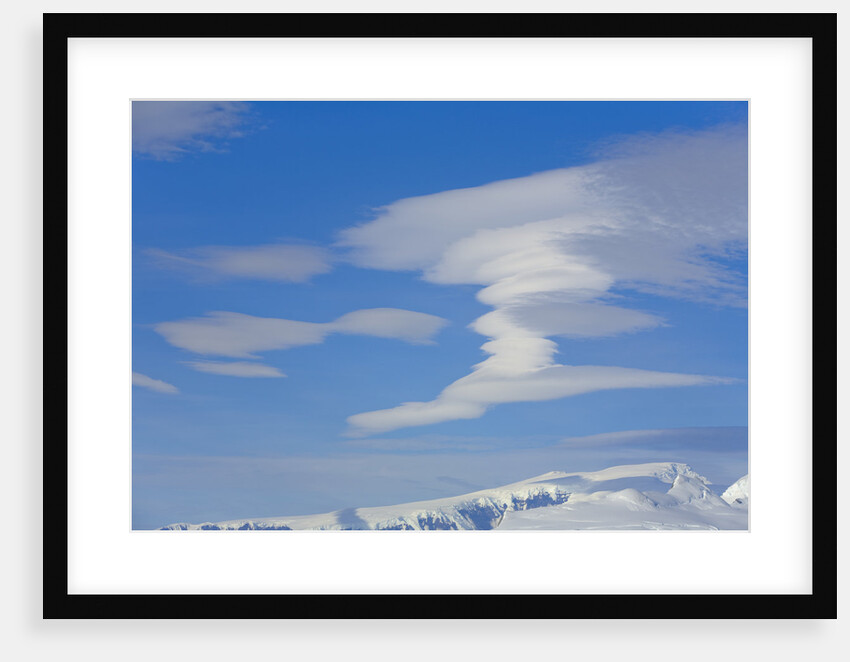 Lenticular Clouds Floating above Snow-covered Glacier by Anonymous