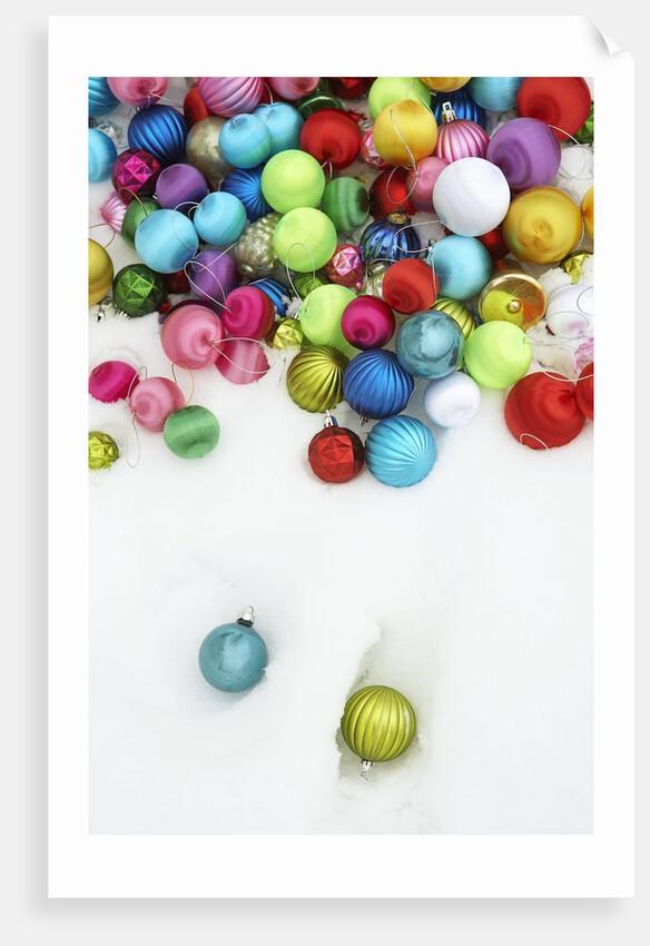 Christmas ornaments on snow by Anonymous