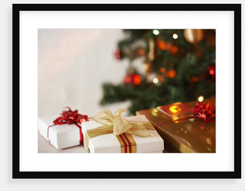 Gifts under a Christmas tree by Anonymous