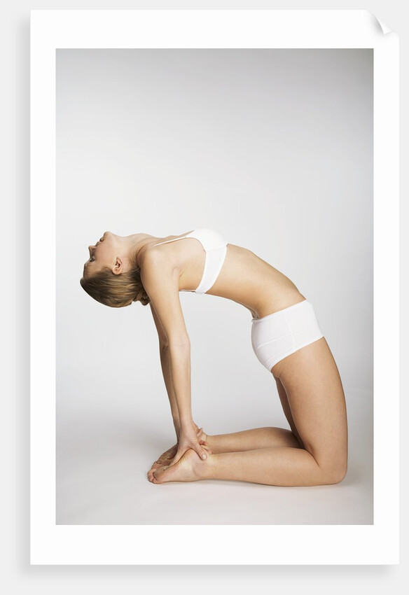 Woman stretching in camel pose by Anonymous