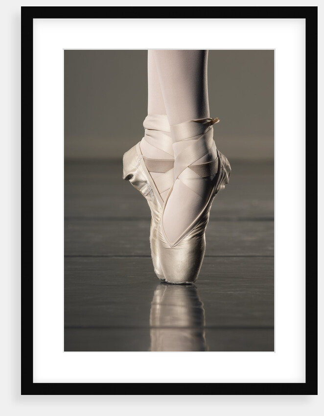 Feet of ballet dancer en pointe by Anonymous