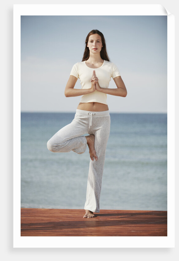 Woman doing yoga by the ocean by Anonymous