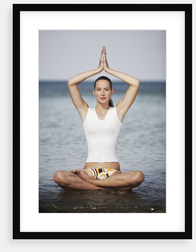 Woman meditating in the ocean by Anonymous