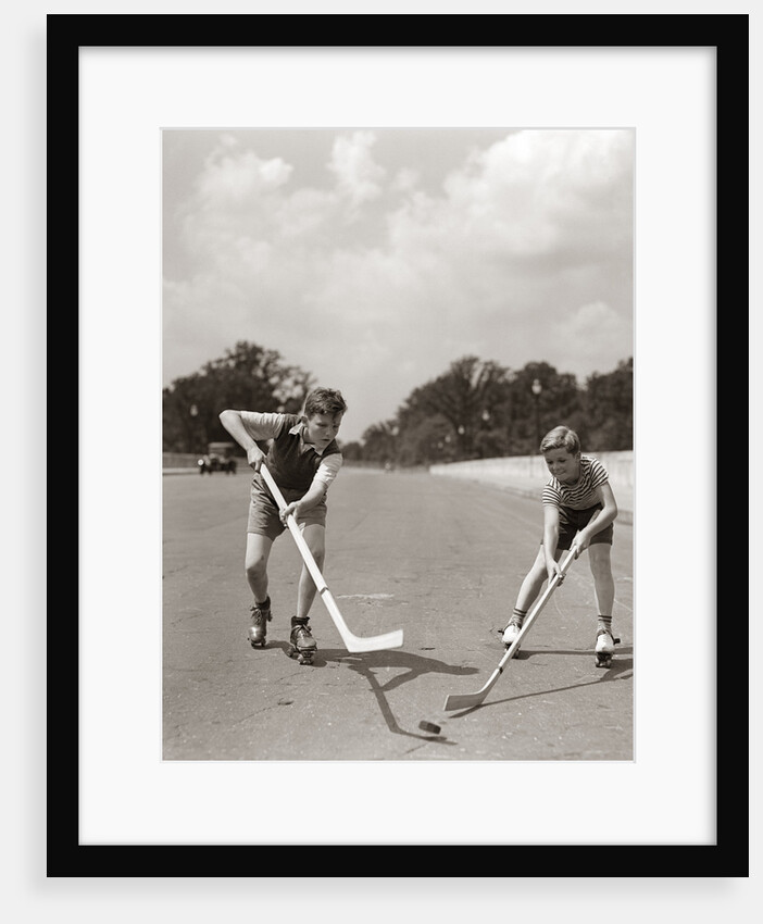 1930s 1940s 2 Boys With Sticks And Puck Wearing Roller Skates Playing Street Hockey by Anonymous