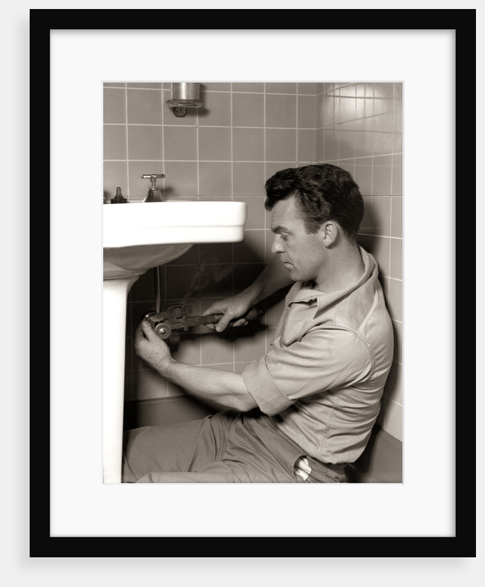 1950s Man Plumber Fixing Bathroom Sink by Anonymous