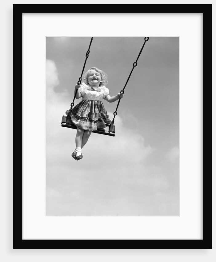 1950s Laughing Little Girl Swinging High On Outdoor Swing by Anonymous
