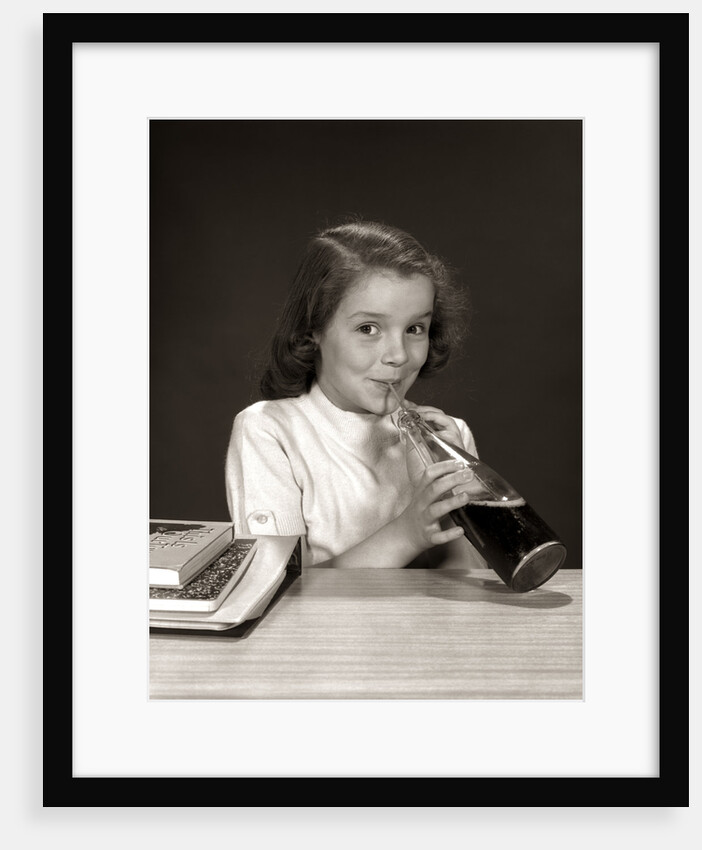 1950s 1960s School Girl Using Straw Drinking Carbonated Beverage From Bottle by Anonymous