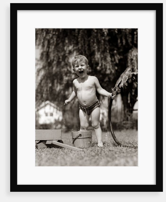1940s 1950s Wet Young Boy Toddler Outside Playing With Water Hose by Anonymous