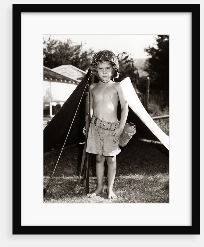 1950s Boy Playing Soldier Standing With Rifle Helmet Canteen Tent by Anonymous