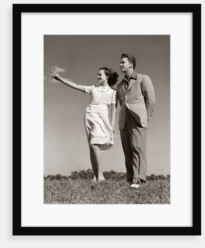1940s Teenage Couple Standing Together Outdoors Girl Pointing by Anonymous
