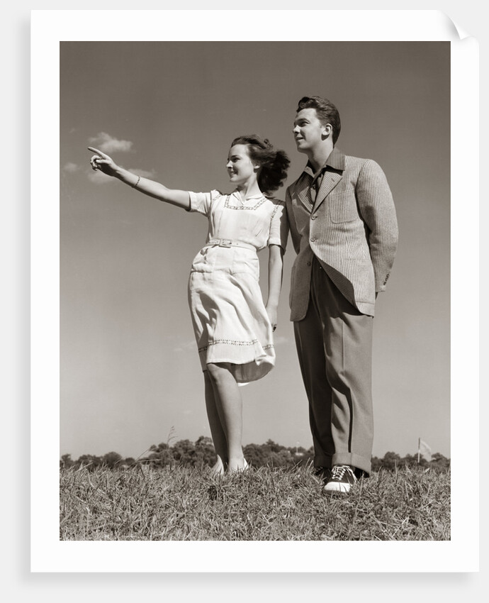 1940s Teenage Couple Standing Together Outdoors Girl Pointing by Anonymous