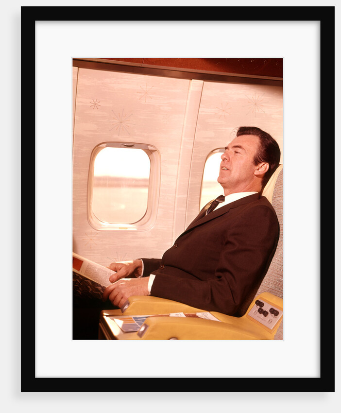 1960s Man Sitting In First Class Airplane Passenger Seat by Anonymous