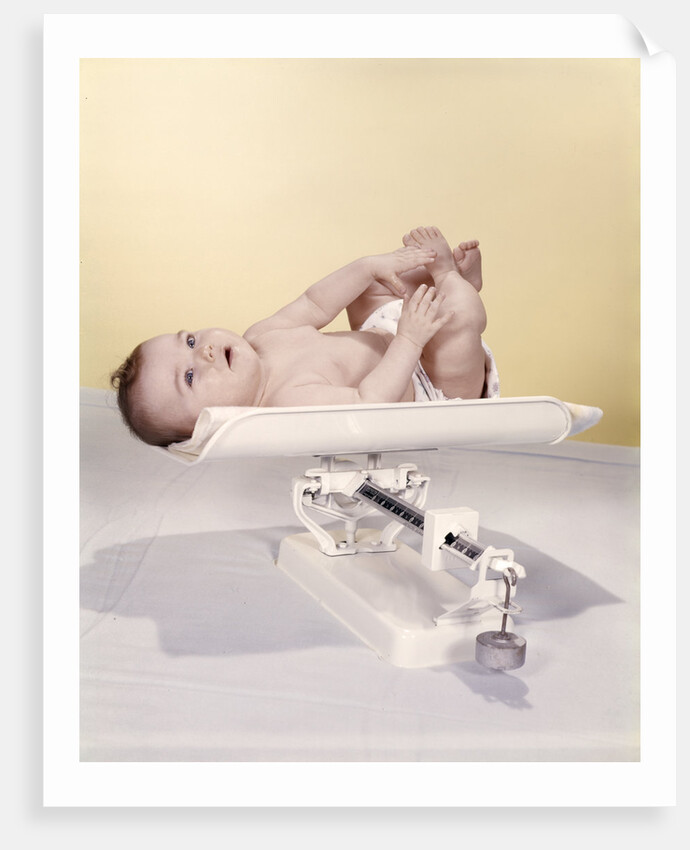 1950s 1960s Baby Lying On Weight Scale by Anonymous