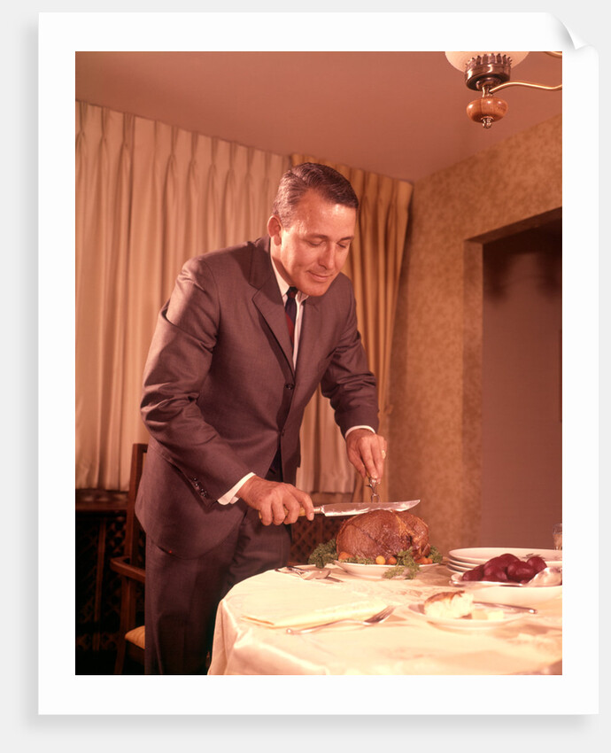 1960s Well-Dressed Man Carving Roast Beef At Dinner Table by Anonymous