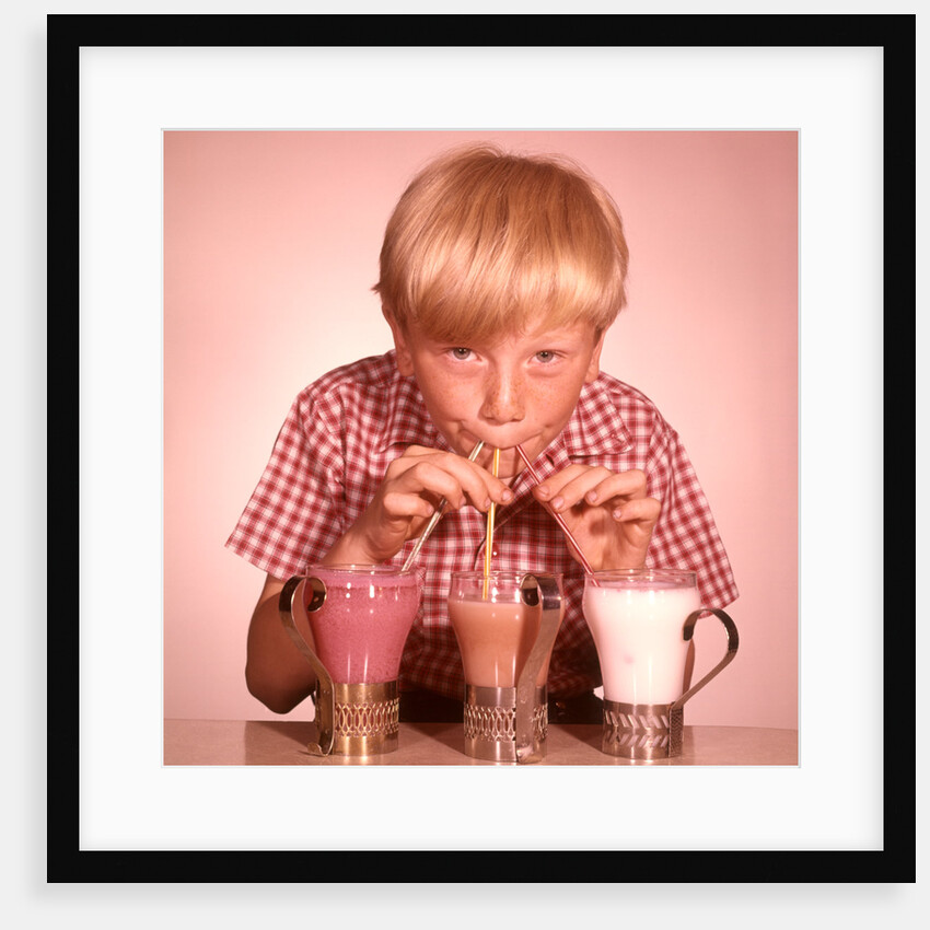 1950s 1960s Boy Drinking Three Milkshakes Through A Straw At Same Time by Anonymous