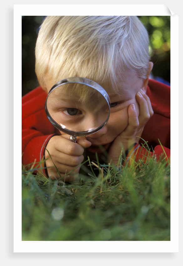 1980s Boy Using Magnifying Glass by Anonymous