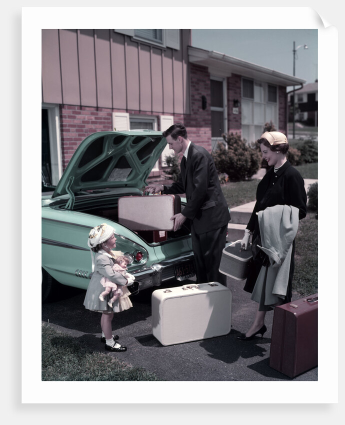 1950s Family Mother Father Daughter In Front Of Suburban House Packing Luggage In Car For Vacation by Anonymous