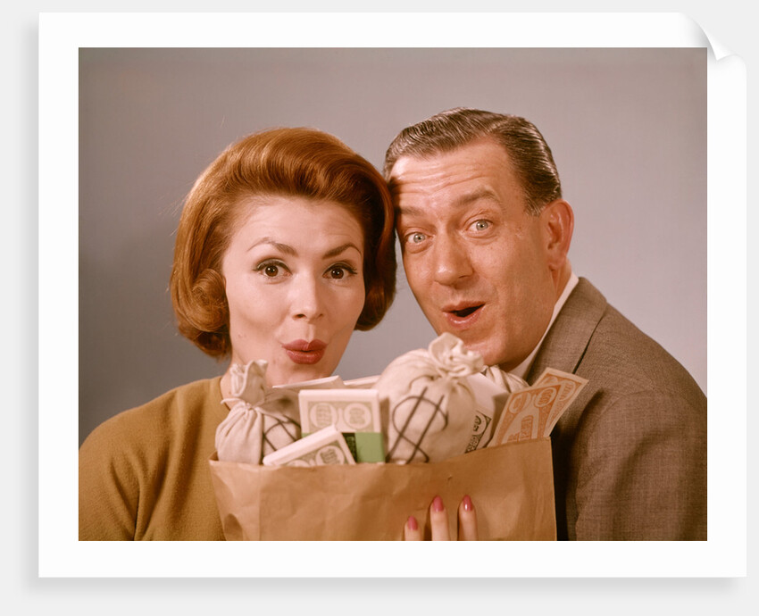 1960s Surprised Happy Couple Man Woman With Grocery Bag Filled With Money by Anonymous