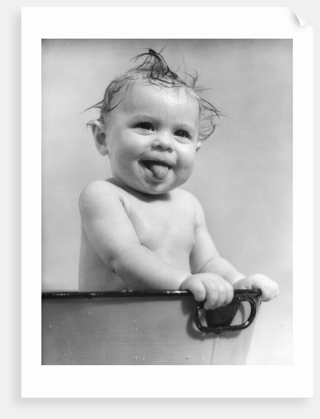 1940s 1930s Wet Baby Sitting In Tub Sticking Out Tongue by Anonymous