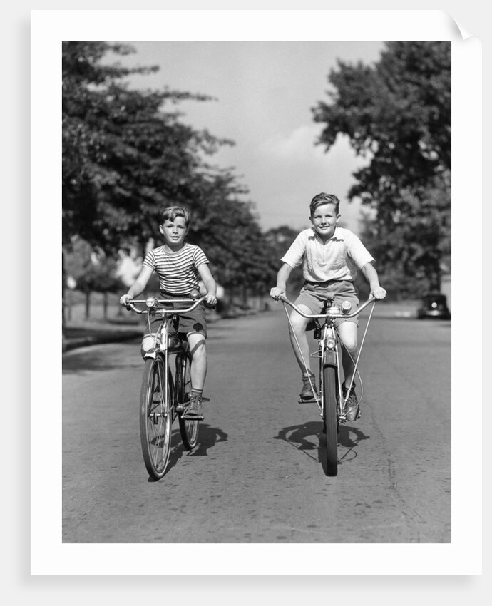 1930s 1940s Two Boys Riding Bikes On Tree Lined Street by Anonymous