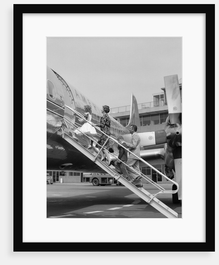 1950s Family Boarding Propeller Airliner By Climbing Gangway Stairs At Airport by Anonymous