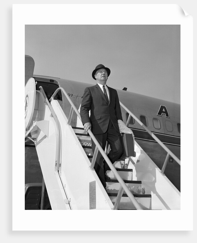 1960s Businessman Deplaning From Airplane Wearing Hat And Carrying Overcoat And Briefcase by Anonymous