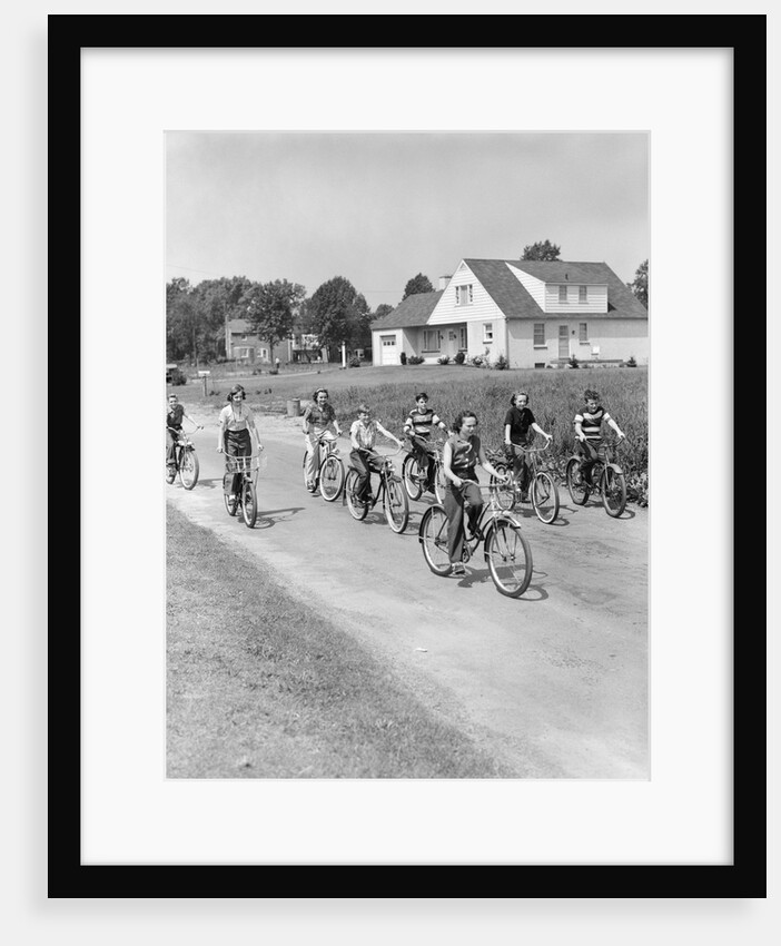 1950s 8 Kids Boys and Girls Ride Bicycles On Country Rural Road Lane Fun House In Background by Anonymous