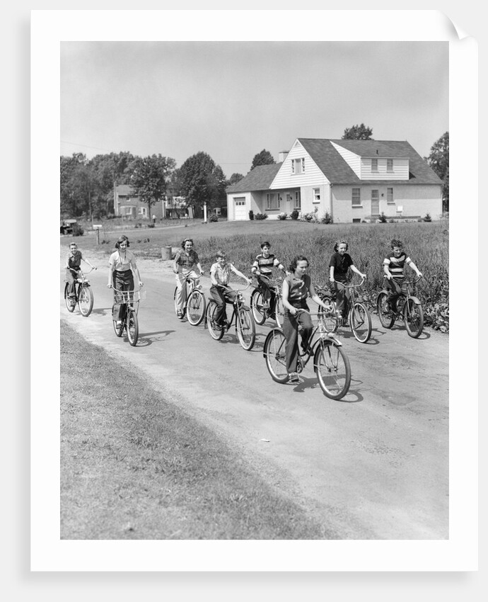 1950s 8 Kids Boys and Girls Ride Bicycles On Country Rural Road Lane Fun House In Background by Anonymous