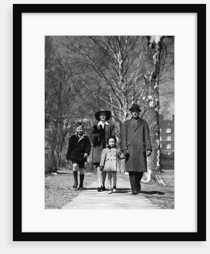 1930s 1940s Family Walking Forward Winter Suburban Sidewalk by Anonymous