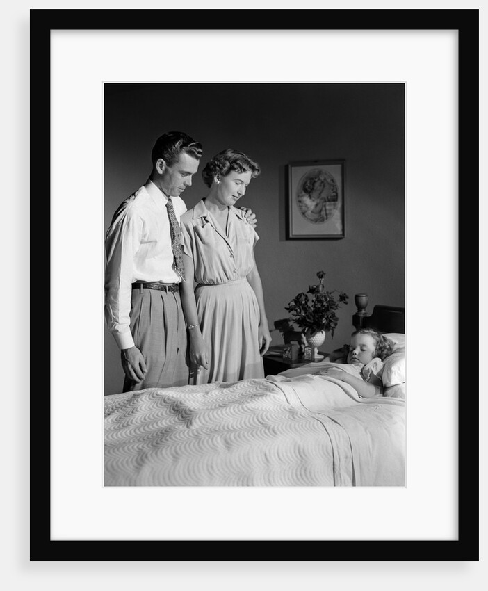1950s Mother And Father Watching Sleeping Daughter by Anonymous
