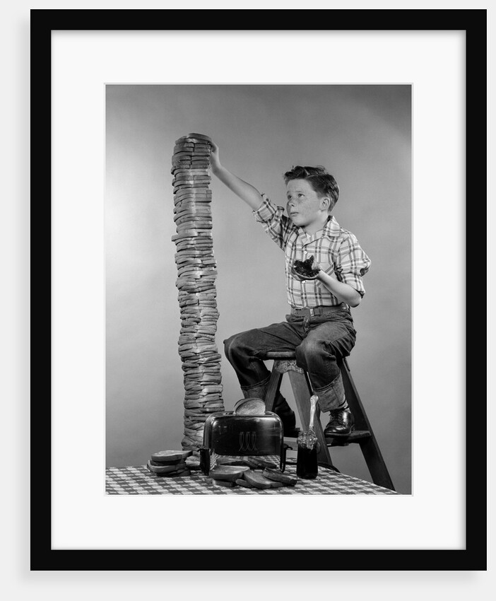 1950s Boy Eating Jelly Toast Sitting On Ladder Stacking Up Tall Pile Of Toast From Toaster by Anonymous