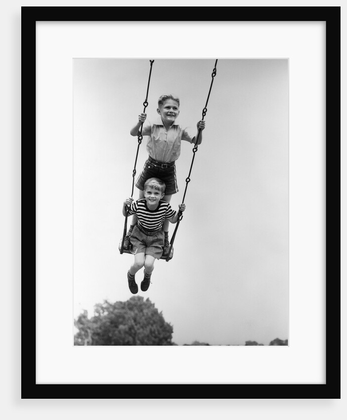 1930s Two Boys Sitting Standing On Playground Swing by Anonymous