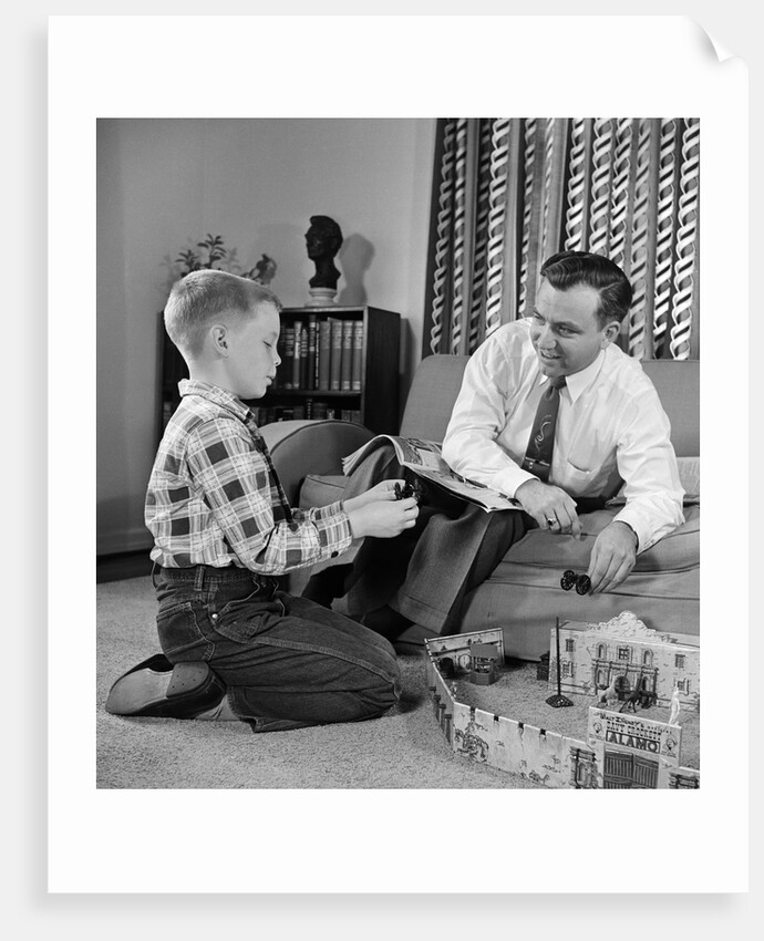 1950s Father And Son Playing With Cowboy Toy Game In Living Room Indoor by Anonymous