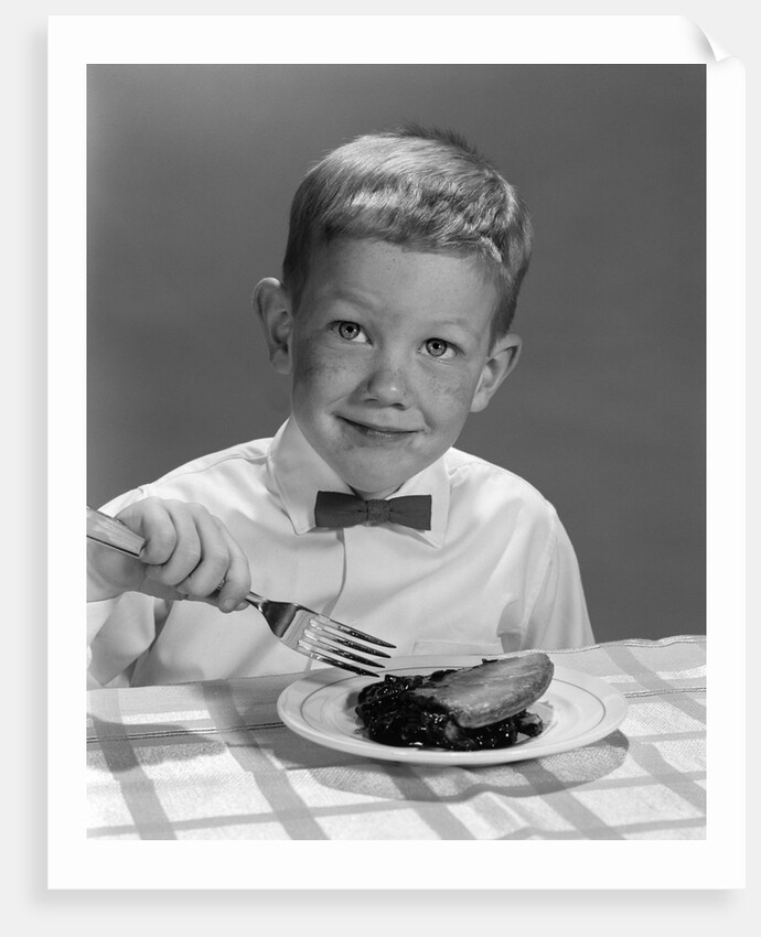 1960s Boy Wearing Bow Tie Eating Pie Dessert With Fork by Anonymous