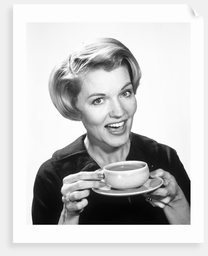 1960s Woman Drinking Coffee Holding Cup And Saucer by Anonymous