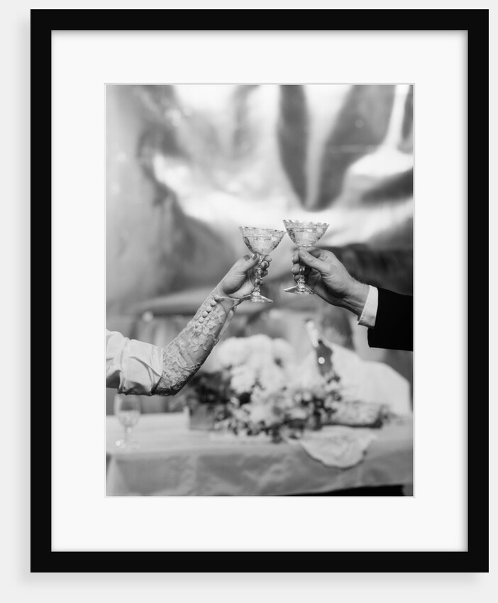 Hands and Arms Of A Bride And Groom Toasting With Champagne Glasses by Anonymous