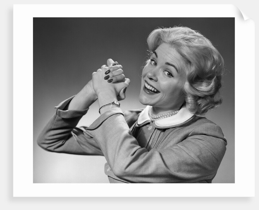 1950s 1960s Woman Making Winning Symbolic Hand Gesture With Raised Clasped Hands by Anonymous