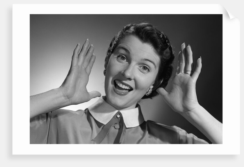 1950s Happy Woman Holding Hands Up Beside Her Head by Anonymous