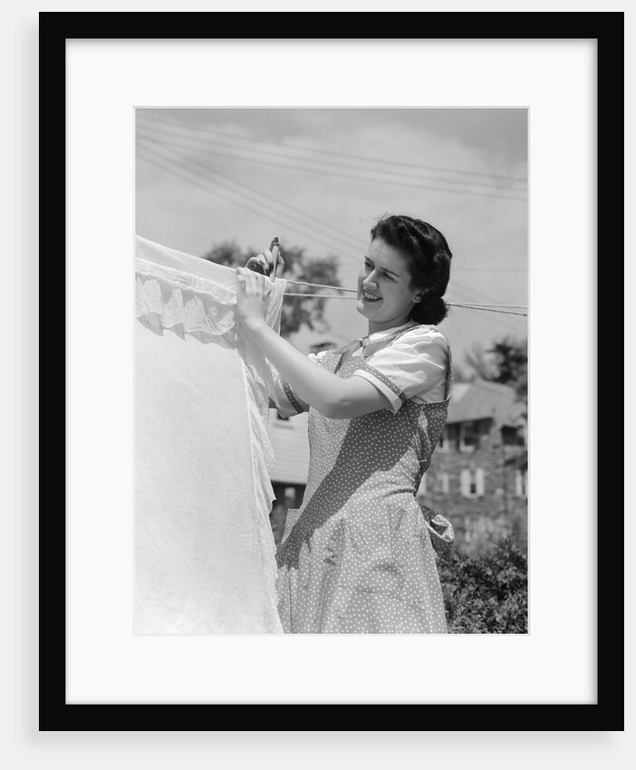 1940s Woman Hanging Laundry On Clothesline Outdoors by Anonymous